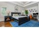 Primary bedroom with tray ceiling featuring neutral colors and an office area at 174 Pearl Se St, Atlanta, GA 30316