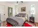 Inviting bedroom showcases a full bed, artwork, wood floors, and an ensuite bathroom at 174 Pearl Se St, Atlanta, GA 30316