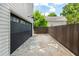 Long driveway leading to a garage with a modern black door and a privacy fence at 174 Pearl Se St, Atlanta, GA 30316