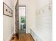 Entryway with built-in storage bench and hardwood floors, leading to the rest of the home at 174 Pearl Se St, Atlanta, GA 30316