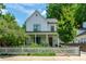 Charming two-story home with white picket fence, well-manicured lawn, and inviting front porch at 174 Pearl Se St, Atlanta, GA 30316