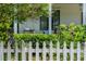 Landscaped front yard featuring a white picket fence, lush greenery, and a cozy porch swing at 174 Pearl Se St, Atlanta, GA 30316