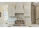 The kitchen features stainless appliances, white cabinetry, and tile backsplash at 174 Pearl Se St, Atlanta, GA 30316