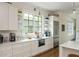 Bright kitchen features stainless appliances, white cabinetry, and under cabinet microwave at 174 Pearl Se St, Atlanta, GA 30316