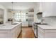 Bright spacious kitchen features stainless appliances, white cabinetry, and hardwood floors at 174 Pearl Se St, Atlanta, GA 30316
