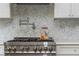 Close-up of a kitchen with stainless steel range and tile backsplash at 174 Pearl Se St, Atlanta, GA 30316