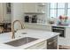 Bright kitchen featuring a stainless steel sink, marble countertop, and modern appliances at 174 Pearl Se St, Atlanta, GA 30316