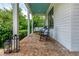 Relaxing front porch with brick flooring, porch swing, rocking chairs, and a blue ceiling at 174 Pearl Se St, Atlanta, GA 30316