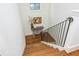 Wood staircase featuring an iron railing, a window and light colored walls at 174 Pearl Se St, Atlanta, GA 30316