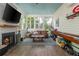 Inviting sunroom features a fireplace, and comfortable seating, creating a perfect relaxation space at 174 Pearl Se St, Atlanta, GA 30316