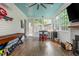 Bright sunroom features shiplap walls, tile floors, a serving area, fireplace, and a game table at 174 Pearl Se St, Atlanta, GA 30316