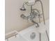 Close-up of the bath tub faucet featuring a chrome finish and telephone-style shower wand at 174 Pearl Se St, Atlanta, GA 30316