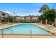 Community swimming pool with lounge chairs, fence and a well-manicured lawn at 3301 Henderson Mill Rd # 1, Atlanta, GA 30341