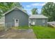 Back of the home featuring vinyl siding, back yard, door, and small deck at 3358 Lake Dr, Lawrenceville, GA 30044