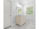 Light and airy bathroom features a white vanity with marble top, a large mirror, and neutral walls at 3358 Lake Dr, Lawrenceville, GA 30044