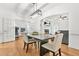 Bright dining room with wood floors, modern light fixture, and open to living room at 3358 Lake Dr, Lawrenceville, GA 30044