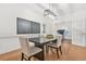 Elegant dining room featuring a modern light fixture, stylish chairs, and hardwood floors at 3358 Lake Dr, Lawrenceville, GA 30044