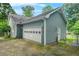 Exterior shot of home and garage, featuring landscaping, and outdoor lighting fixtures at 3358 Lake Dr, Lawrenceville, GA 30044