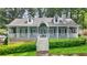 Charming home featuring a welcoming front porch, well-manicured landscaping, and a classic architectural design at 3358 Lake Dr, Lawrenceville, GA 30044