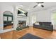 Comfortable living room with a cozy fireplace, hardwood floors, and plush seating at 3358 Lake Dr, Lawrenceville, GA 30044