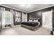 This bedroom features neutral carpet, dark grey walls, large windows, and an ensuite bathroom at 3358 Lake Dr, Lawrenceville, GA 30044