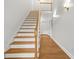 Elegant staircase with wood steps and white risers, complemented by a classic wooden banister at 3358 Lake Dr, Lawrenceville, GA 30044