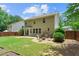 Spacious backyard featuring a cozy fire pit area, a well-maintained lawn, and a privacy fence at 4020 New Salem Ct, Cumming, GA 30040