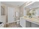 A well-lit bathroom with a vanity, commode, wood-look floors, and a tiled shower with glass doors at 4020 New Salem Ct, Cumming, GA 30040