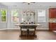 Charming dining area with hardwood floors, wainscoting, and ample natural light from the large windows at 4020 New Salem Ct, Cumming, GA 30040
