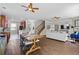 Open floor plan with dining area flowing into the living room and kitchen with a breakfast bar and stairs at 4020 New Salem Ct, Cumming, GA 30040