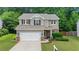 Charming two-story home with a well-manicured lawn and a two-car garage in a suburban neighborhood at 4020 New Salem Ct, Cumming, GA 30040