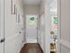 Bright hallway with hardwood floors, leading to a naturally lit room, and featuring modern wall decor at 4020 New Salem Ct, Cumming, GA 30040