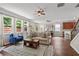Open-concept living area featuring hardwood floors, a fireplace, and a seamless transition to the dining area at 4020 New Salem Ct, Cumming, GA 30040