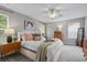 Cozy main bedroom with neutral tones, plush carpeting, and ample natural light from two large windows at 4020 New Salem Ct, Cumming, GA 30040