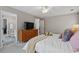 Spacious main bedroom featuring a ceiling fan, carpet, view of the ensuite bathroom, and walk-in closet at 4020 New Salem Ct, Cumming, GA 30040