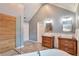 Stylish bathroom featuring double sinks, soaking tub, glass enclosed shower, and wooden accents at 1504 Terminal Ct, Mcdonough, GA 30252