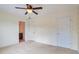 Bedroom with a ceiling fan, two doors, and view into adjacent room at 1504 Terminal Ct, Mcdonough, GA 30252