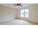 Cozy bedroom featuring a ceiling fan and a large window providing ample natural light at 1504 Terminal Ct, Mcdonough, GA 30252