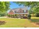 Charming two-story brick home with a well-manicured lawn and mature trees at 1504 Terminal Ct, Mcdonough, GA 30252