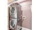 Efficient laundry room with stacked washer and dryer unit at 1504 Terminal Ct, Mcdonough, GA 30252
