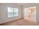 Bright living room featuring a large window and neutral carpeting at 1504 Terminal Ct, Mcdonough, GA 30252