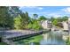 Aerial view of community featuring tennis court, lake with water feature, and several apartment buildings at 305 Mill Pond Se Ct, Smyrna, GA 30082