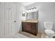 Bathroom features granite vanity, modern fixtures, tile flooring, and a linen closet at 305 Mill Pond Se Ct, Smyrna, GA 30082
