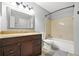 Well-lit bathroom with a wooden vanity, framed mirror, and shower-tub combo at 305 Mill Pond Se Ct, Smyrna, GA 30082