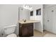 Bathroom features vanity with sink and mirror, complemented by a nearby storage unit and white door at 305 Mill Pond Se Ct, Smyrna, GA 30082