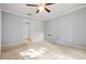 Carpeted bedroom with bright walls and natural lighting and a closet down the hall at 305 Mill Pond Se Ct, Smyrna, GA 30082