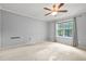 Sun-filled bedroom featuring plush carpet, neutral walls, and a large window at 305 Mill Pond Se Ct, Smyrna, GA 30082