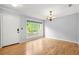 Bright dining room with a chandelier, large window, and hardwood floors at 305 Mill Pond Se Ct, Smyrna, GA 30082