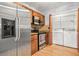 Modern kitchen featuring stainless steel appliances, wooden cabinets, and laundry area at 305 Mill Pond Se Ct, Smyrna, GA 30082