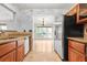 View of kitchenette with sink, granite counters, wooden cabinets, and open floor plan at 305 Mill Pond Se Ct, Smyrna, GA 30082